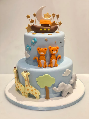 2 tiered Christening cake decorated with sugar animals and an arc