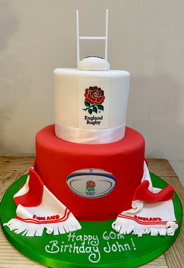 two tiered rugby themed birthday cake with rugby goal and a scarf and england rugby branding