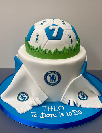Cake designed like a soccer ball with Chelsea FC logo, featuring scarves and half a football