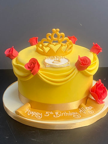 Birthday cake in theme of Belle beauty and the beast withjred roses and yellow swags