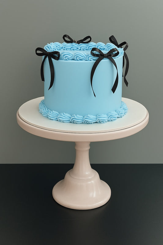 Blue baby shower and birthday cake with ribbons