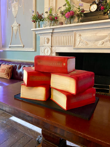 Cakes decorated to look like a stack of red books for a book launch
