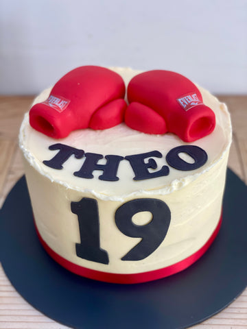 Birthday cake with icing boxing gloves on top