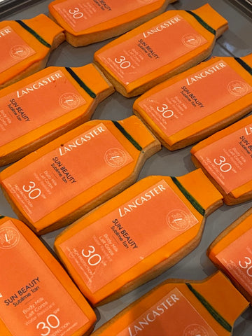 Branded Cookies in shape of sun lotion bottles of Lancaster Sun Beauty SPF 30 sunscreen