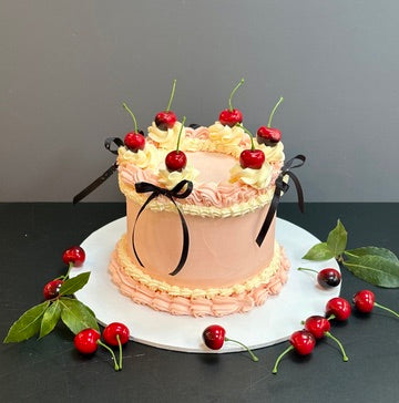 Buttercream cake decorated with cherries and bows ready to order in london