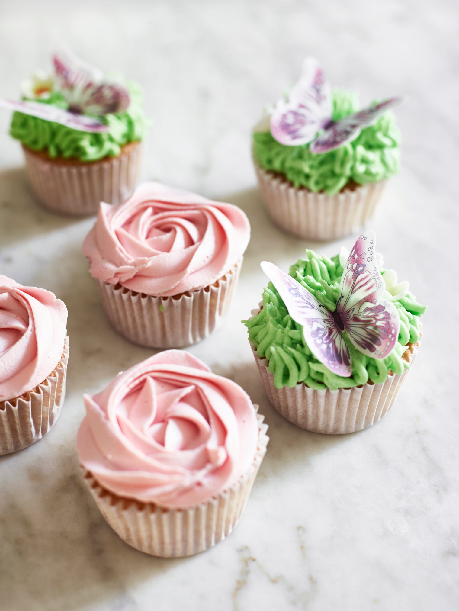 cupcakes decorated with a rose and butterflies