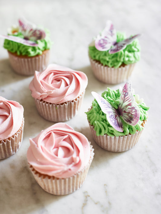 cupcakes decorated with a rose and butterflies