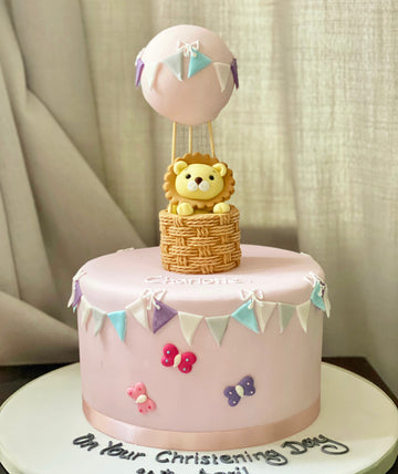 Pretty kids cake decorated with a lion in a hot air balloon