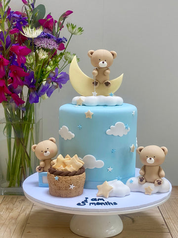 Babyshower or birthday cake decorated with cute teddy bears, moons and stars