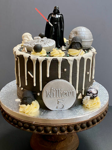 Star Wars-themed birthday cake with darth vadar, death star and millenium star ship