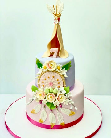 Birthday cake with a dream catcher on the front and a wigwam on top