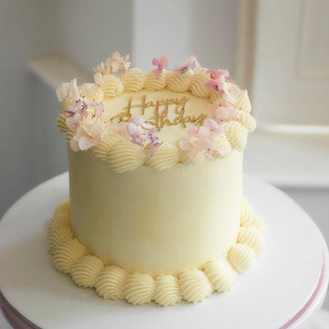 buttercream birthday cake with pink flowers decoration
