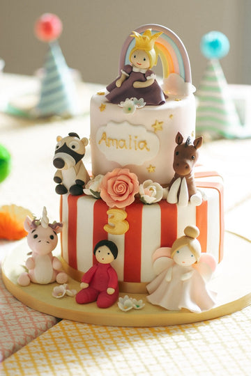 Two tiered cake decorated with their favourite toys