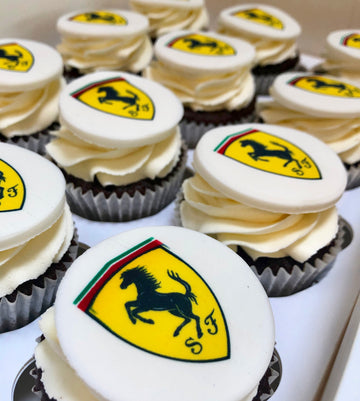Cupcakes with Ferrari logo on white frosting