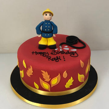 Birthday cake decorated with Fireman Sam and his hose