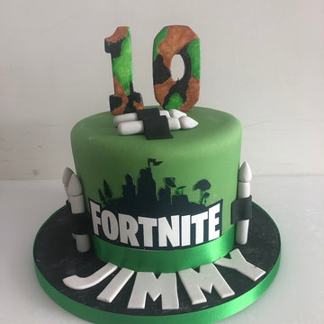 Birthday cake with the fortnite logo and bullets