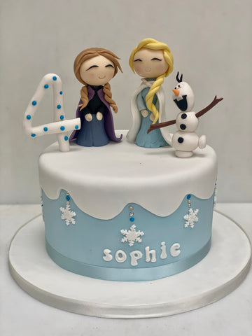 Frozen themed birthday cake with Elsa, Anna and Olaf as sugar figures on top