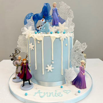 Drip cake decorated with characters from Frozen 2
