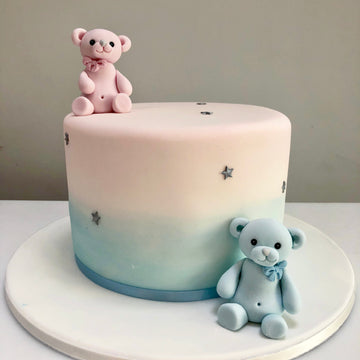 Pink and blue ombre cake with teddies for a gender reveal party