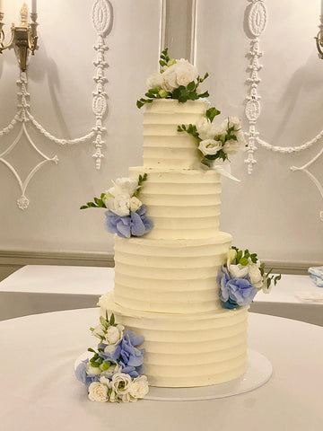 Wedding Cake with Fresh blue and white Flowers and Geometric Ridged Buttercream