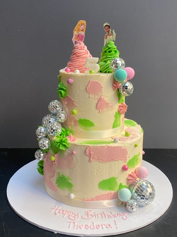birthday cake decorated with glitterballs and disney princesses