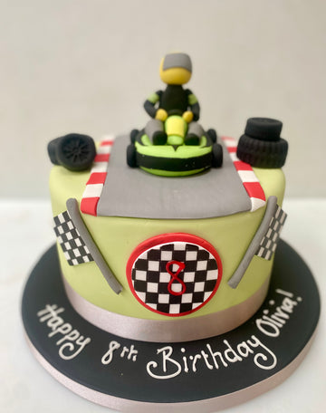 Birthday cake with a go-kart and checkered flags, decorated for a 8th birthday.