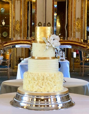 4 tiered wedding cake with buttercream roses, buttercream stripes, dots anda. gold top tier with a sugar peonie to decorate