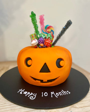 Halloween cake shaped like a pumpkin with sweets in the middle