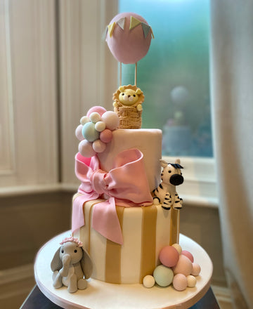 Birthday or christening cake decorated with a hot air balloon and cute sugar animals