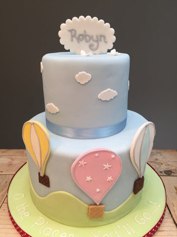 Two-tiered children's birthday cake with hot air balloons