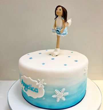 Ombre birthday cake with an ice skating figurine on top