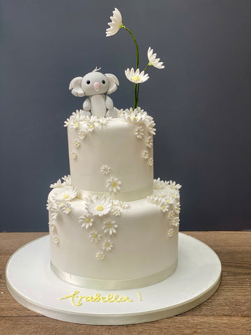 Christening Cake decorated with a sugar koala and lots of daisies cascading down the cake