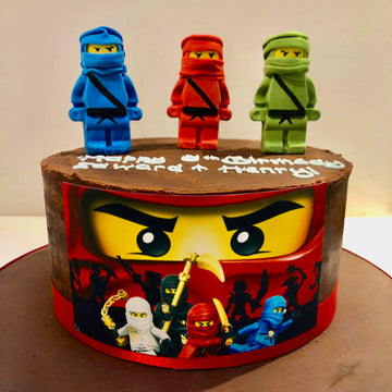 Single tier cake with three ninjago figures on the top