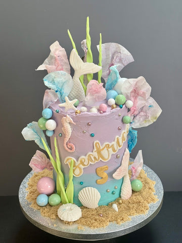 Ombre birthday cake with mermaid tails and rice paper sails