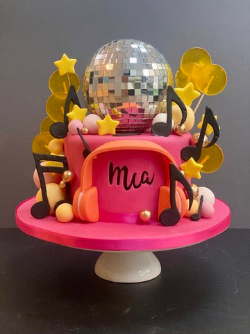 Birthday cake with musical notes, a glitterball and headphones