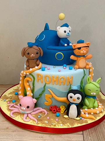 2 Tiered Birthday Cake decorated in the theme of the Octonauts with their submarine, octopus and octonauts characters Captain Barnacles, Kwazi and Peso