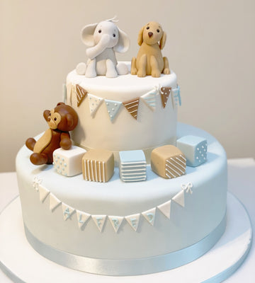 2 Tiered cake decorated with partying animals, bunting and blocks