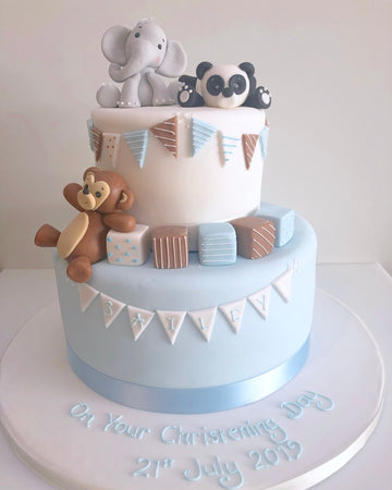 Birthday, christening or babyshower cake with partying naughty animals on top to decorate