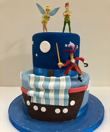 front of the cake a pirate ship with captain hook, peter pan and tinkerbell