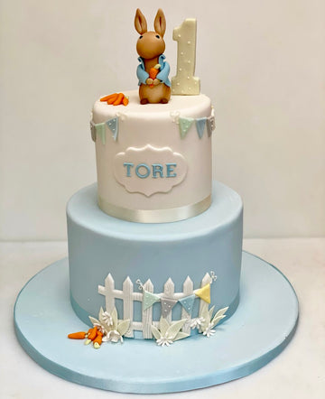 Birthday and christening cake decorated with peter rabbit and his garden
