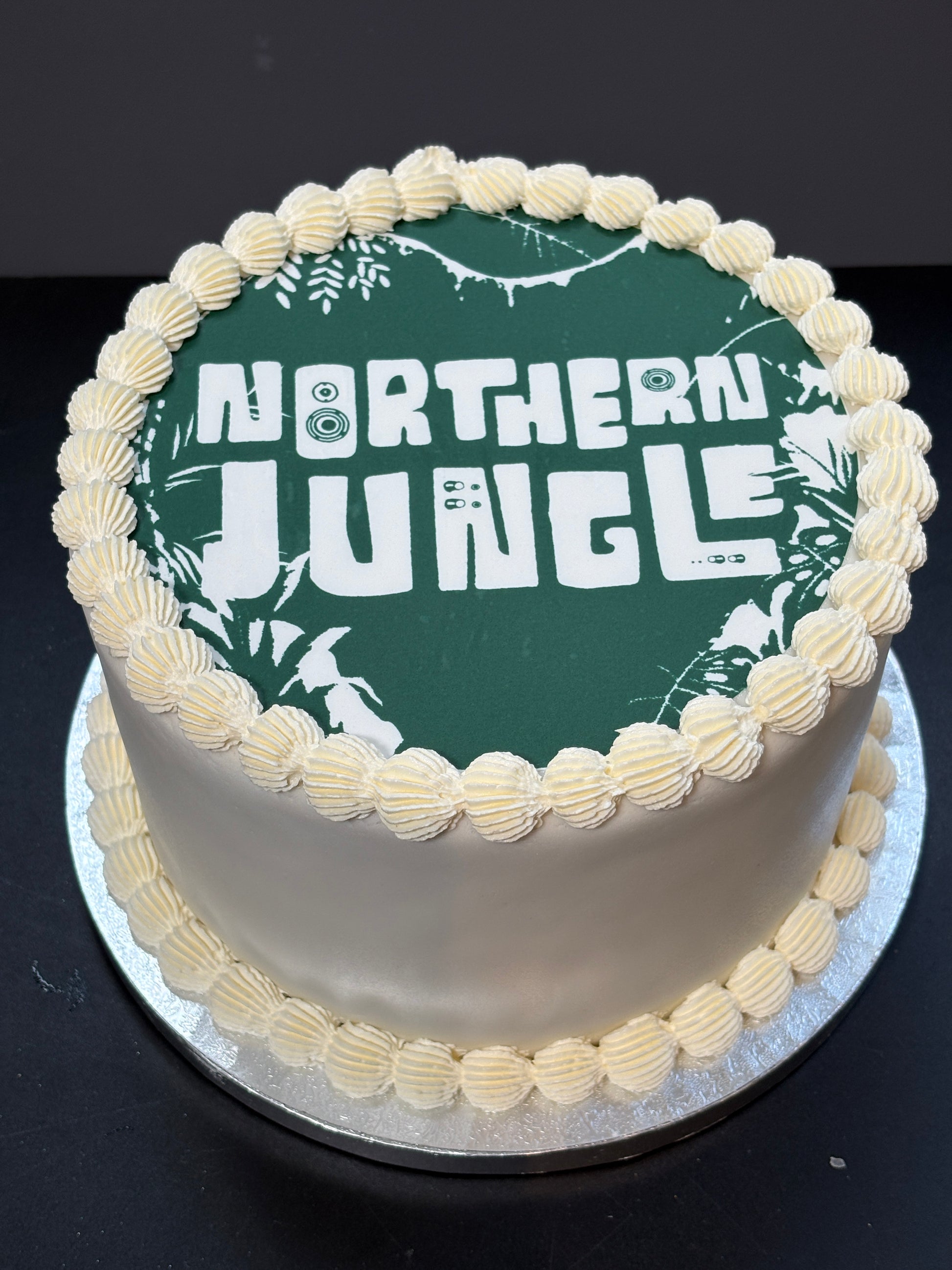 Cake with an edible printed image on top, finished with lambeth piping