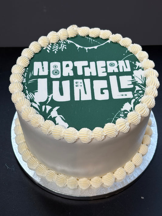 Cake with an edible printed image on top, finished with lambeth piping
