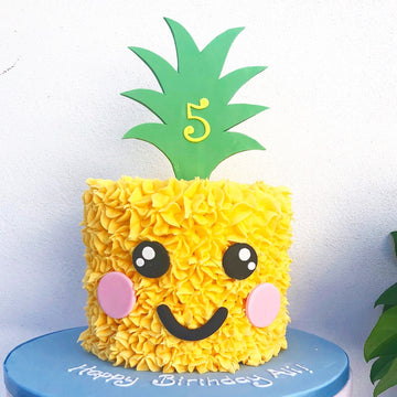 Pineapple-shaped birthday cake with a number 5 on a white background