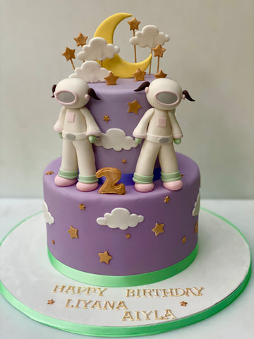 Girlie Astronaut themed birthday cake with purple icing and two twin astronauts