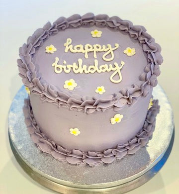 Buttercream birthday cake in purple with daisy decorations ready to order in london