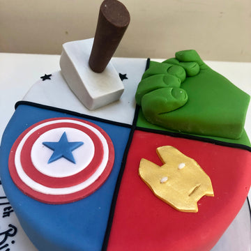 Cake divided between thor, hulk, ironman and captain america decorations