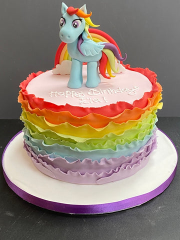 frilled rainbow birthday cake with a sugar figure of rainbow dash on top