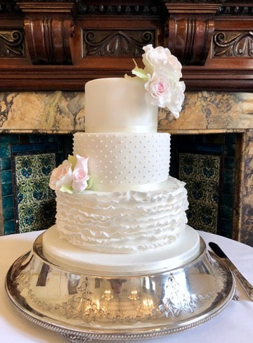 3 tier wedding cake with ruffle bottom tier, polka dot middle tier and pink and white sugar roses delivered in london