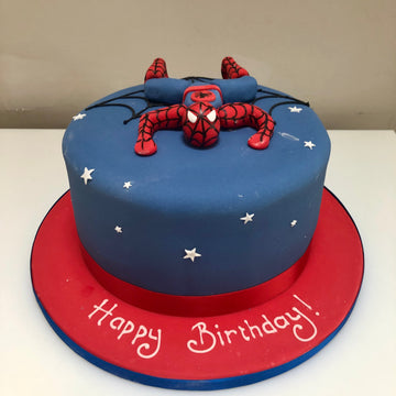 Blue birthday cake with spiderman figure and stars