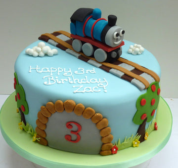 Thomas the tank engine on a single tier birthday cake with a tunnel on the front